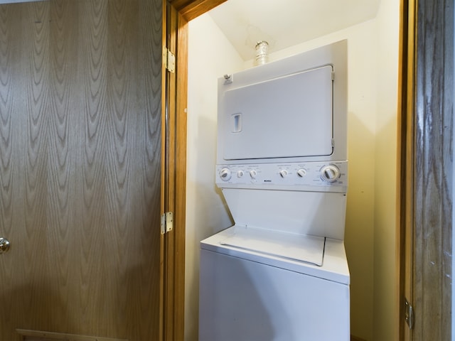 clothes washing area featuring stacked washer and dryer