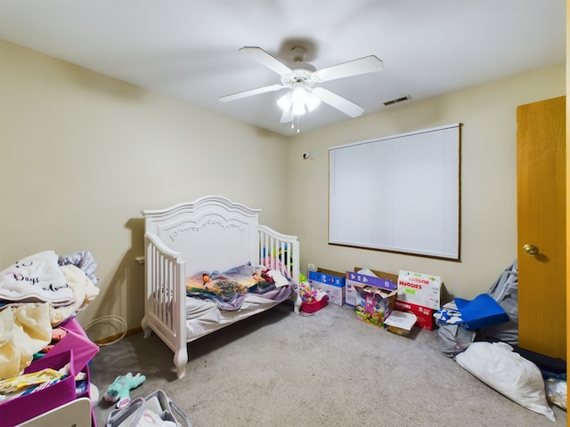 bedroom featuring ceiling fan and carpet