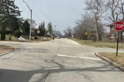 view of road with traffic signs and curbs