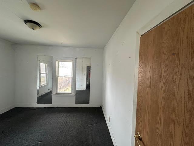 unfurnished room featuring baseboards