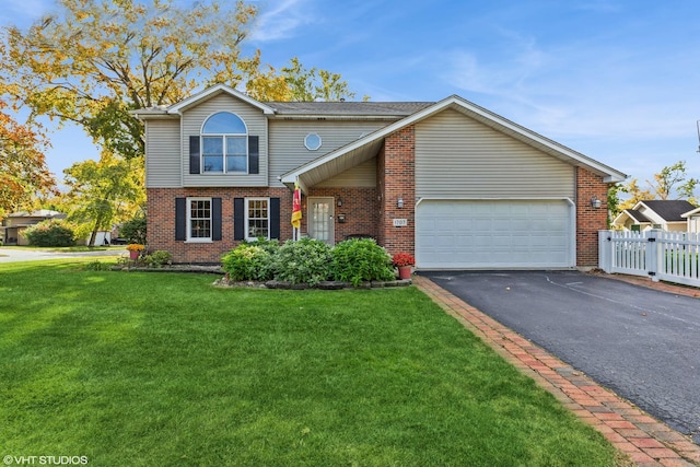 traditional home featuring a garage, driveway, a front lawn, and brick siding