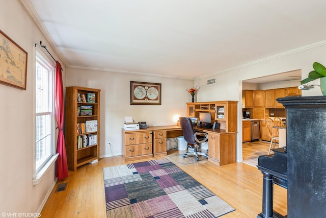 office area with ornamental molding, visible vents, and light wood-style flooring