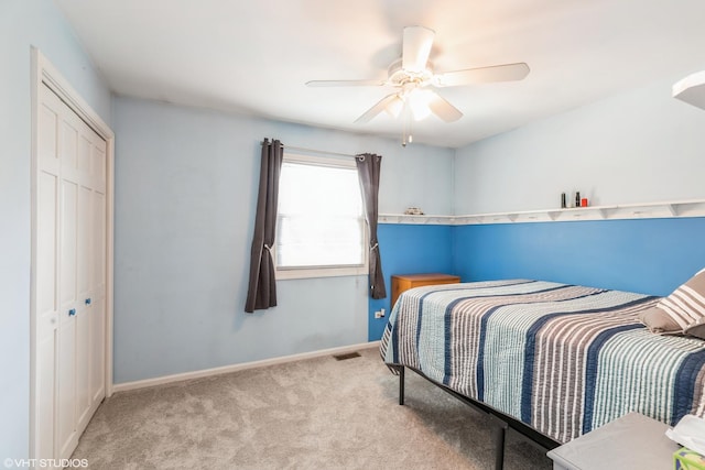 bedroom with light carpet, baseboards, visible vents, a ceiling fan, and a closet