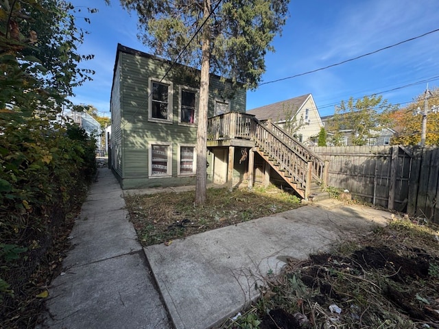 rear view of property featuring a deck