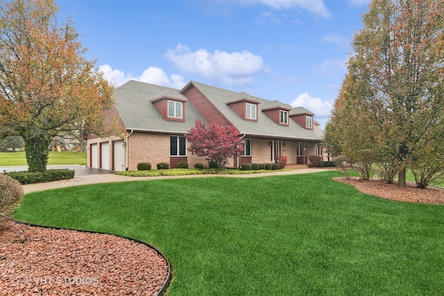 view of front of property with a garage and a front lawn