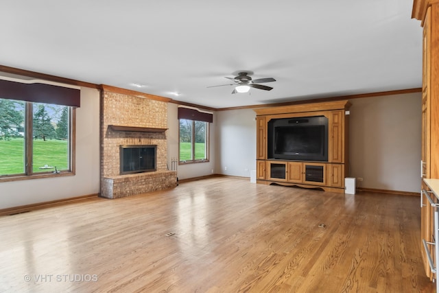 unfurnished living room with ceiling fan, light wood-type flooring, a fireplace, and ornamental molding