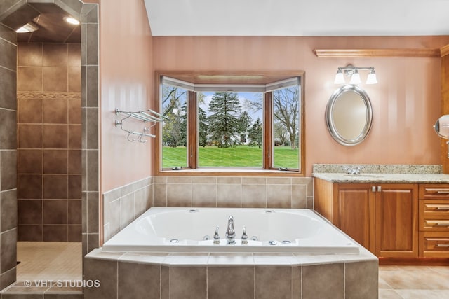 bathroom with tile patterned floors, vanity, and shower with separate bathtub