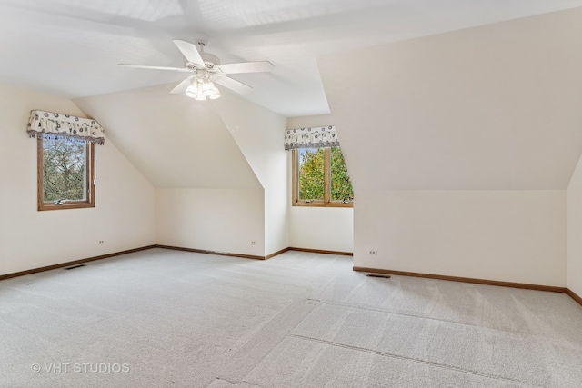 bonus room featuring ceiling fan, lofted ceiling, and light carpet