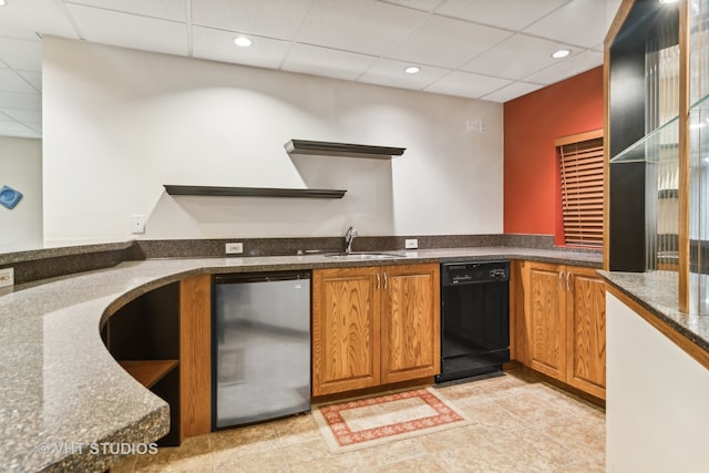 kitchen featuring dishwasher, a drop ceiling, and sink