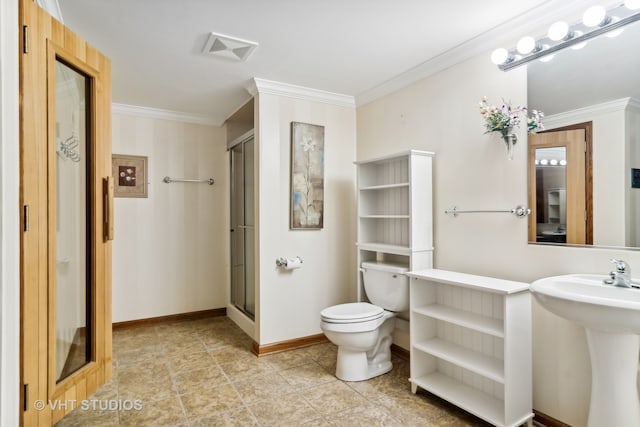 bathroom with toilet, a shower with door, ornamental molding, and sink