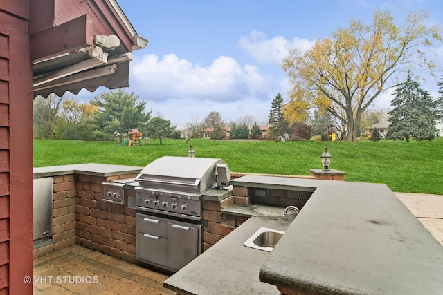 view of patio / terrace with a grill, a playground, area for grilling, and sink