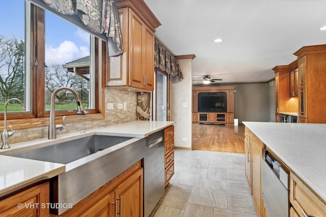 kitchen with decorative backsplash, ceiling fan, dishwasher, and light hardwood / wood-style floors