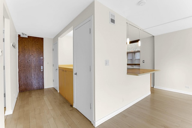 hallway with light wood-type flooring