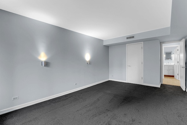 unfurnished bedroom featuring dark carpet