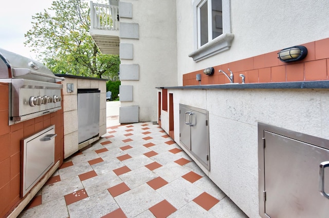 view of patio featuring area for grilling and sink