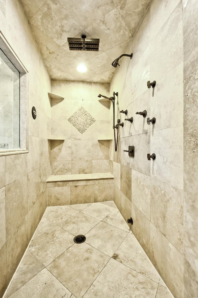 bathroom with tiled shower