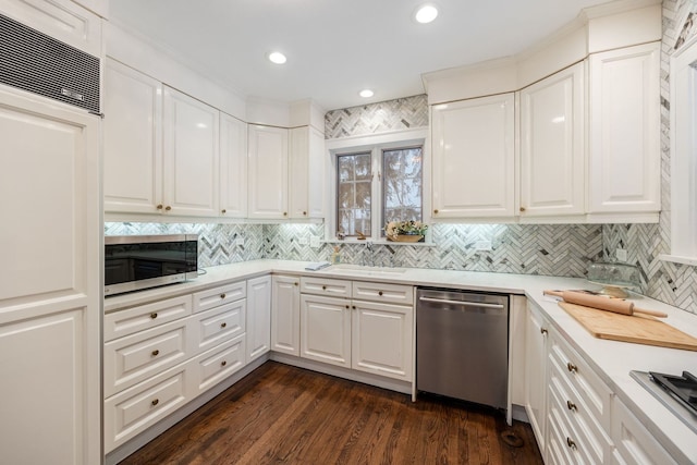 kitchen featuring appliances with stainless steel finishes, tasteful backsplash, white cabinetry, and sink