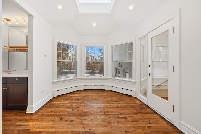 unfurnished sunroom with baseboard heating and lofted ceiling with skylight