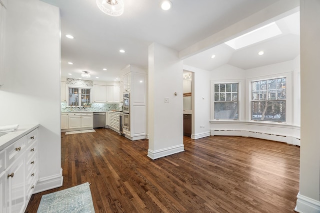 kitchen featuring decorative backsplash, baseboard heating, dark hardwood / wood-style flooring, white cabinetry, and appliances with stainless steel finishes