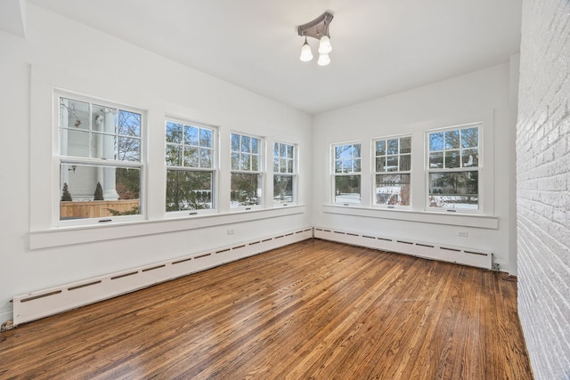 unfurnished sunroom with baseboard heating