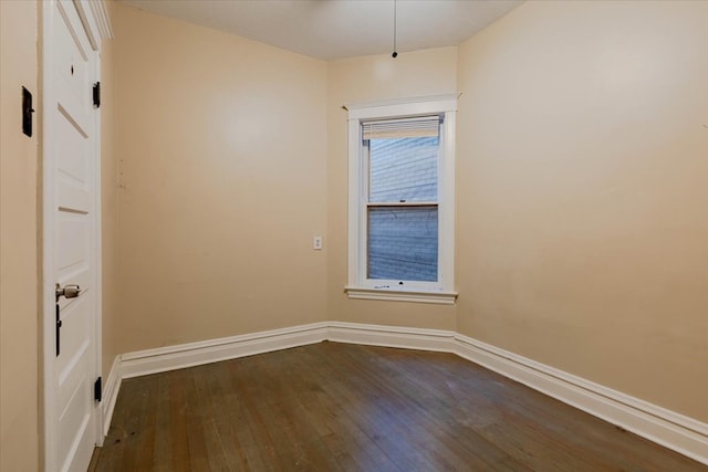 unfurnished room with dark wood-type flooring