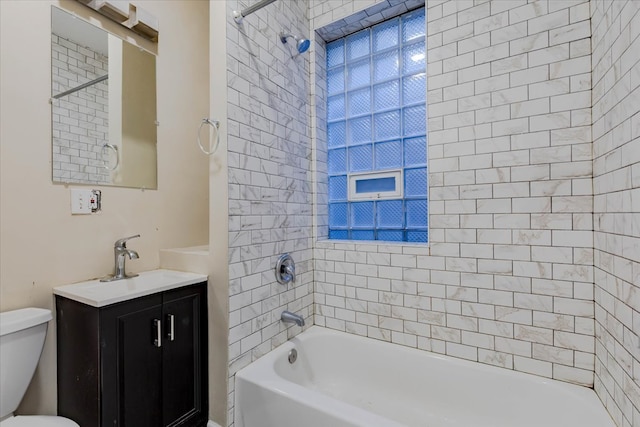 full bathroom with vanity, toilet, and tiled shower / bath