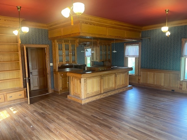 bar with dark wood-type flooring and decorative light fixtures