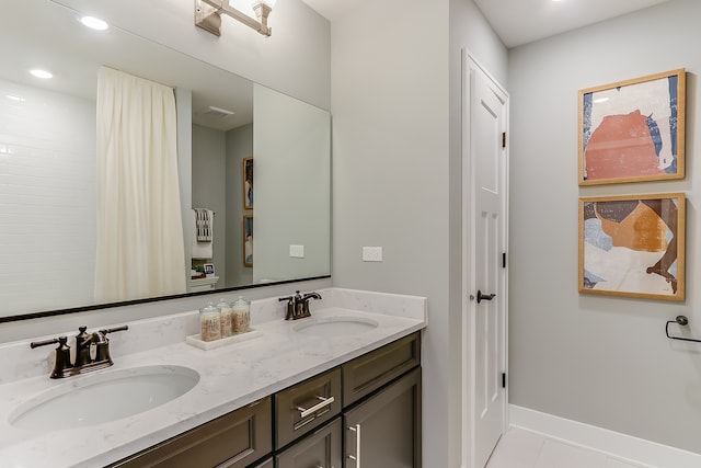 bathroom featuring vanity, a shower with shower curtain, and tile patterned floors