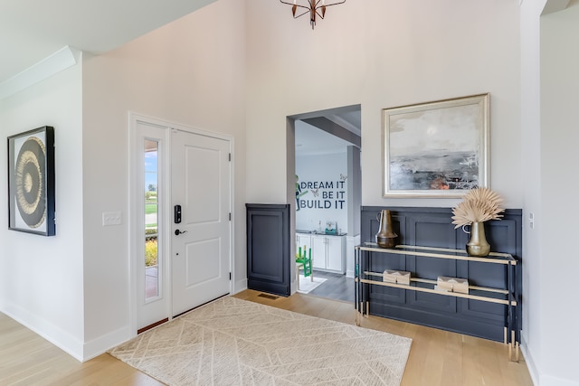 entryway with a towering ceiling and hardwood / wood-style floors