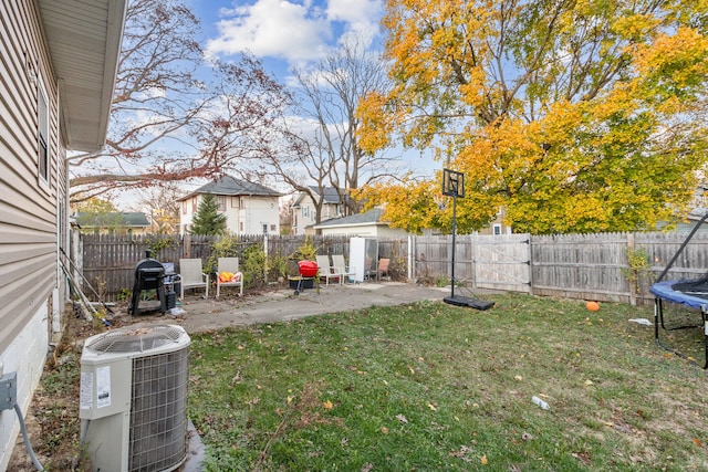 view of yard with a patio area, central AC, and a trampoline