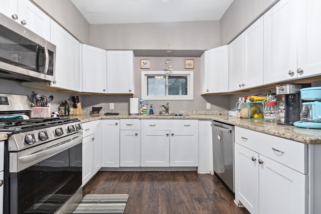 kitchen featuring white cabinets, dark hardwood / wood-style floors, and appliances with stainless steel finishes