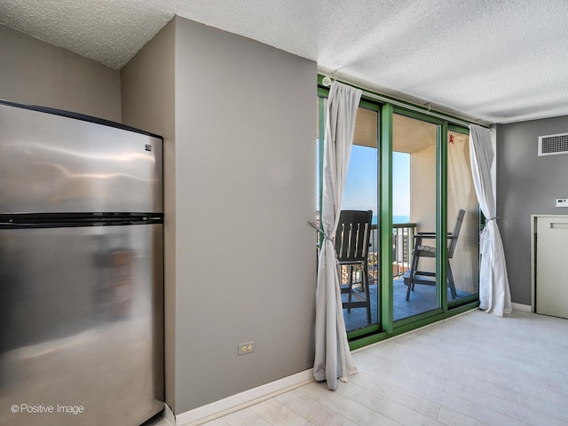 unfurnished room with a textured ceiling