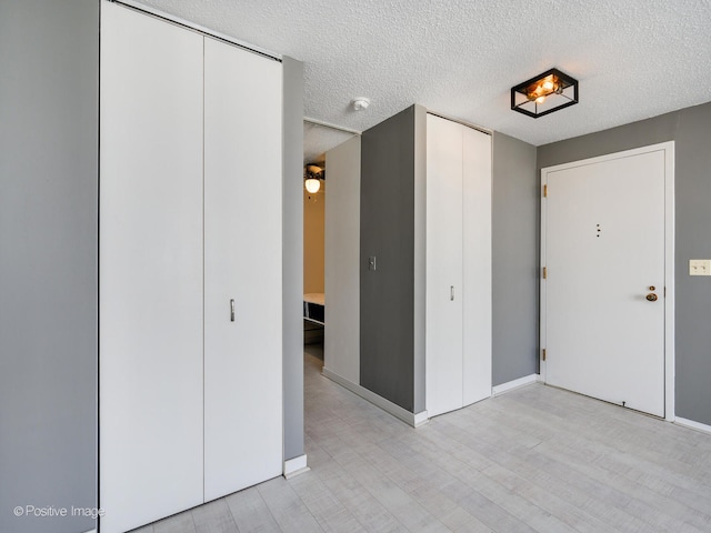 interior space with light hardwood / wood-style flooring and a textured ceiling