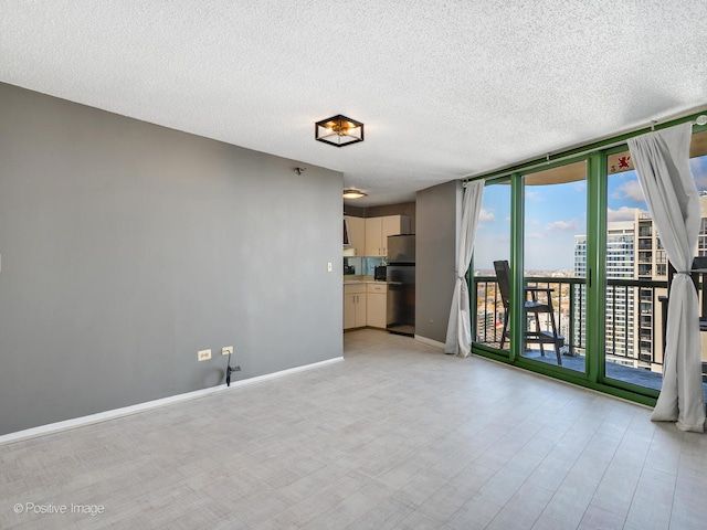 empty room featuring light hardwood / wood-style floors and a textured ceiling