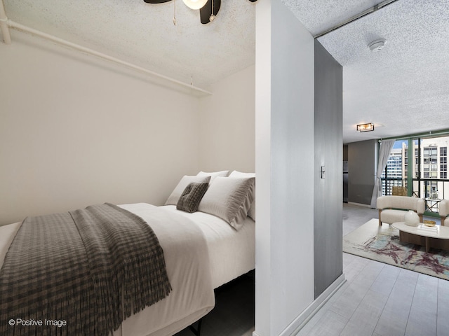 bedroom with a textured ceiling and ceiling fan