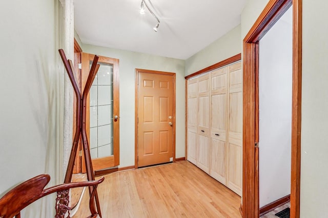 foyer featuring light hardwood / wood-style flooring and rail lighting