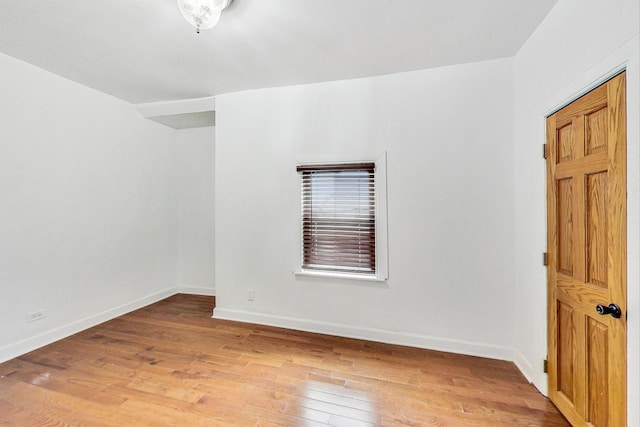 spare room featuring wood-type flooring