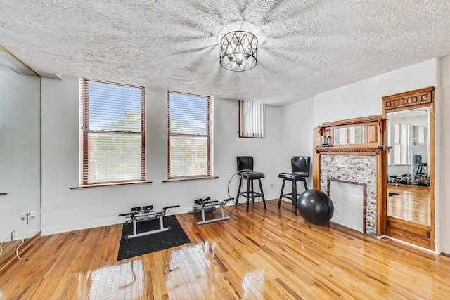 workout area featuring a textured ceiling and hardwood / wood-style flooring