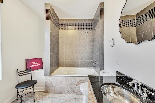 full bathroom with vanity, tiled shower / bath combo, and toilet