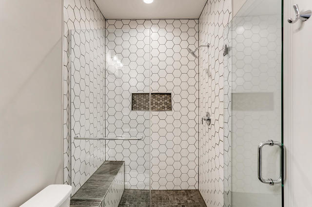 bathroom with toilet and walk in shower