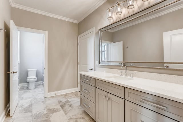 bathroom with vanity, toilet, and crown molding