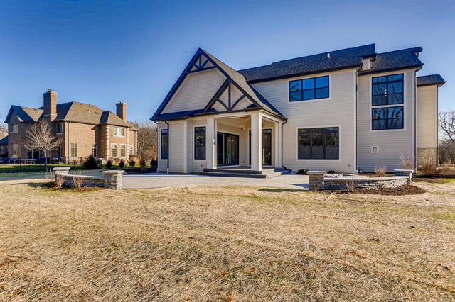 back of property featuring a yard and a patio