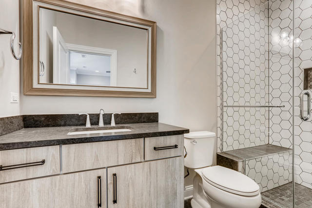 bathroom featuring vanity, toilet, and an enclosed shower