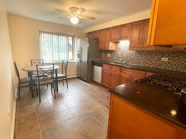 kitchen featuring tasteful backsplash, ceiling fan, ornamental molding, dishwasher, and sink