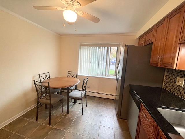 dining space featuring ornamental molding, sink, a baseboard heating unit, and ceiling fan