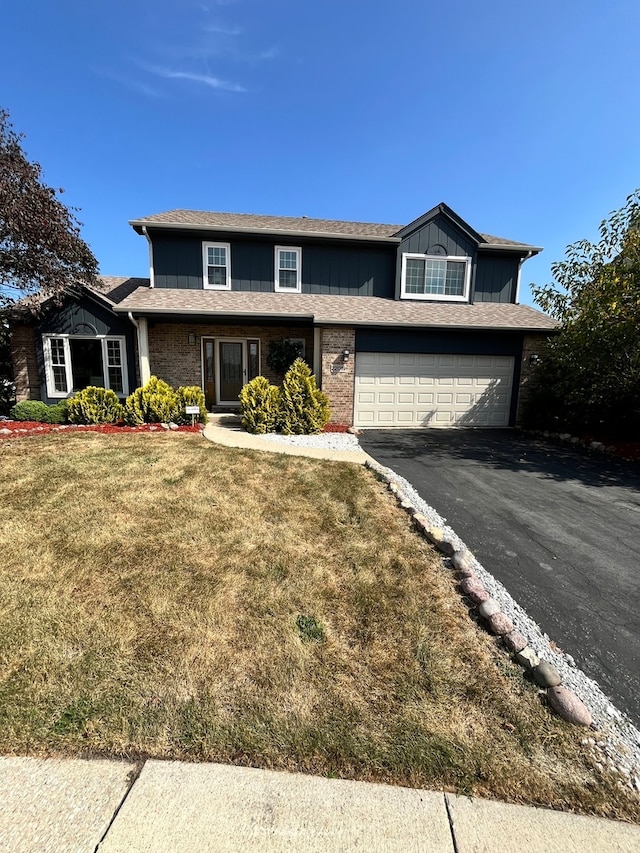 view of property featuring a front yard and a garage