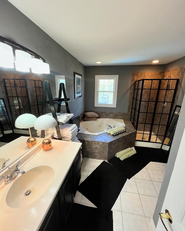 bathroom featuring vanity, tiled tub, and tile patterned flooring