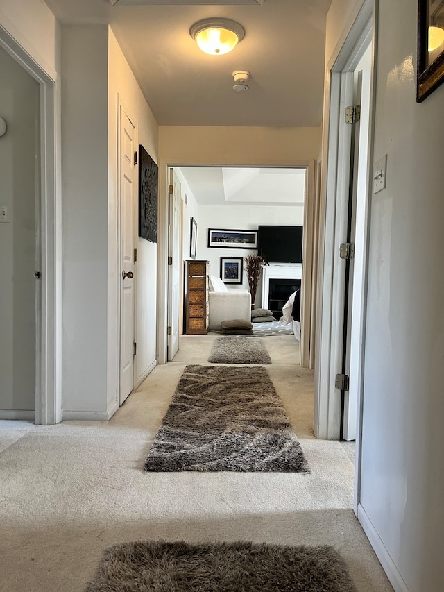 hallway featuring light carpet