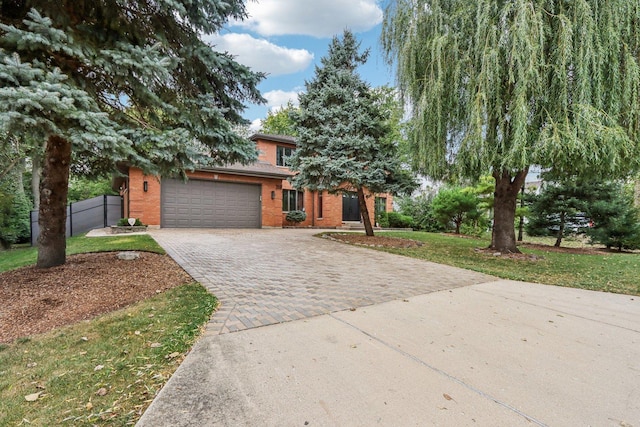 view of front of home featuring a garage and a front lawn