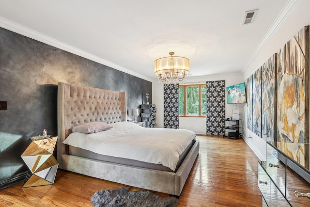 bedroom featuring a chandelier, wood-type flooring, and crown molding